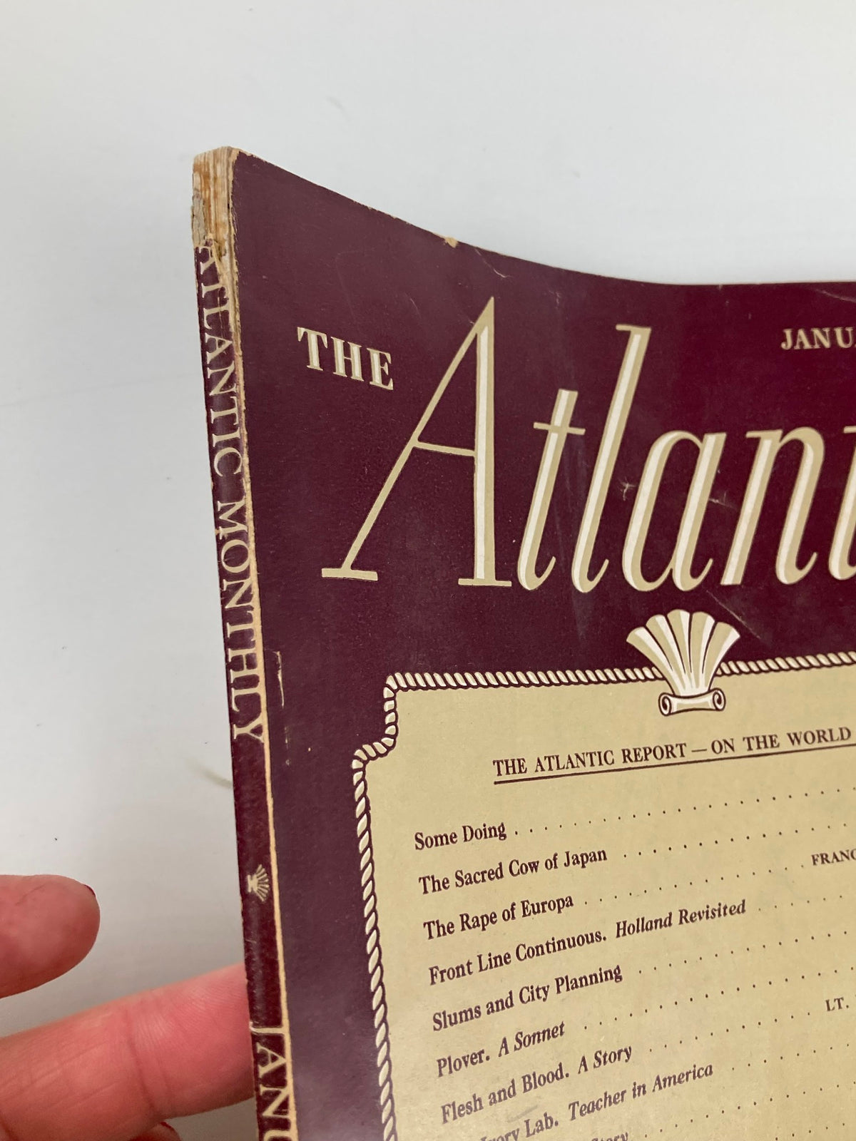 Side view of VTG The Atlantic Magazine January 1945 showing spine wear and the title 'The Sacred Cow of Japan' on the cover.