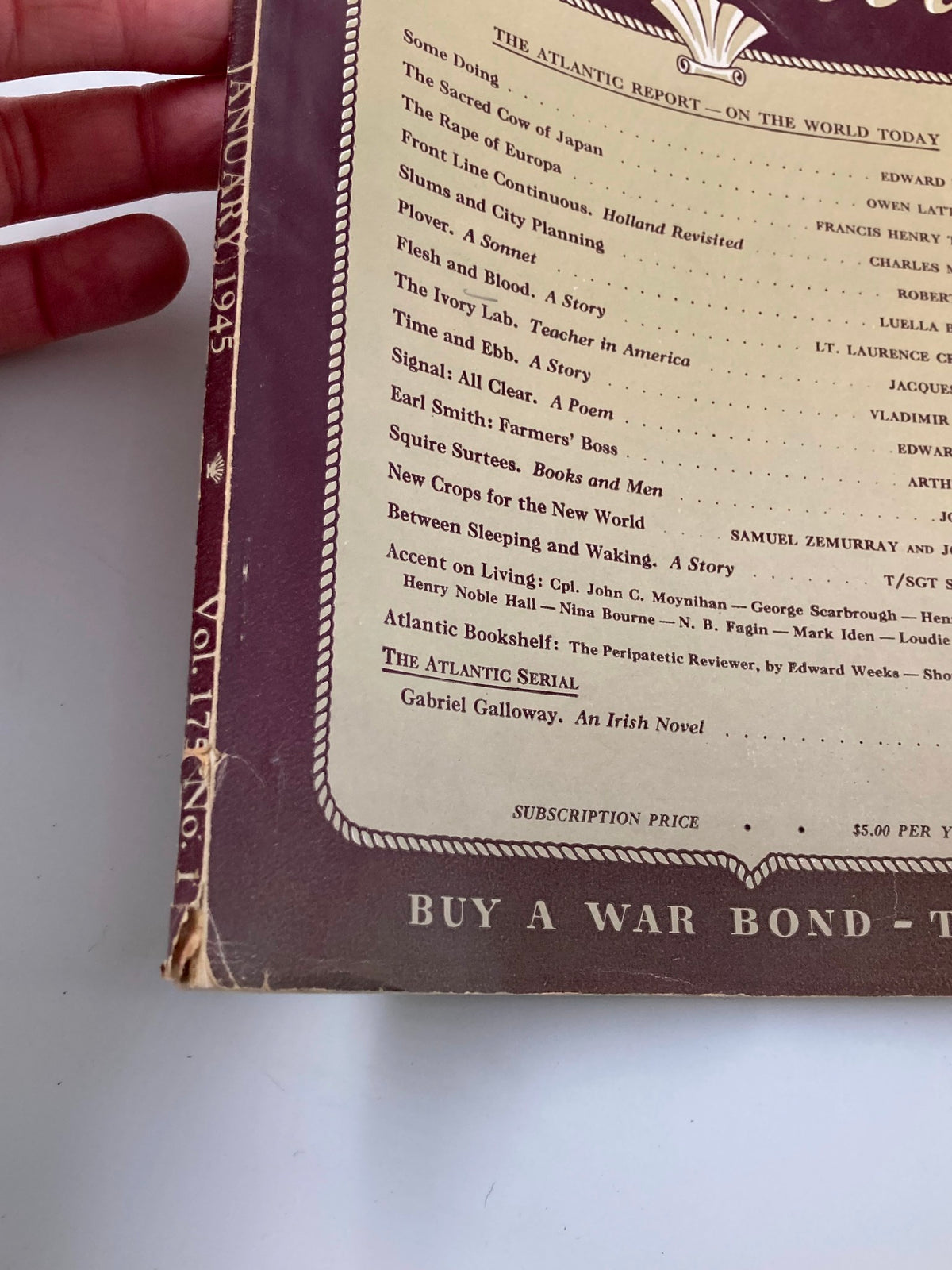 Close-up of the spine and details of VTG The Atlantic Magazine January 1945 showcasing the article 'The Sacred Cow of Japan' and vintage aesthetic.