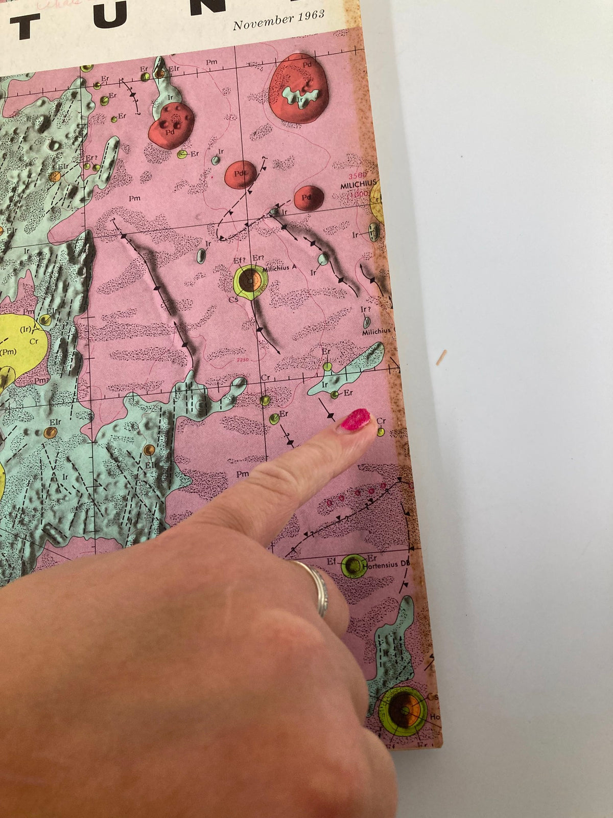 Detailed view of the VTG Fortune Magazine November 1963 cover highlighting the lunar map with a finger pointing at its features.