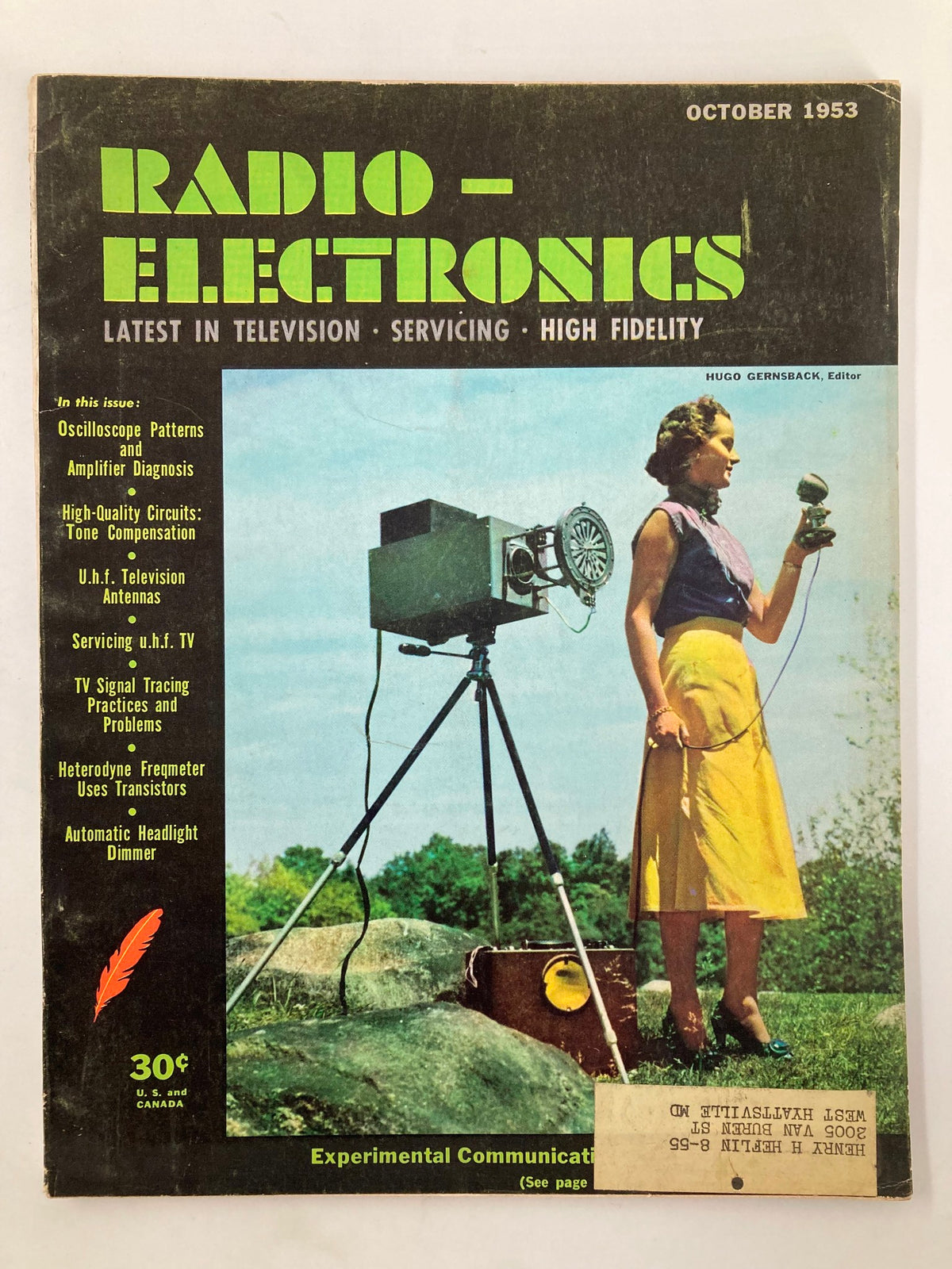 Cover of VTG Radio-Electronics Magazine, October 1953, featuring the article on Automatic Headlight Dimmer, with vintage design elements and a woman outdoors using a microphone.