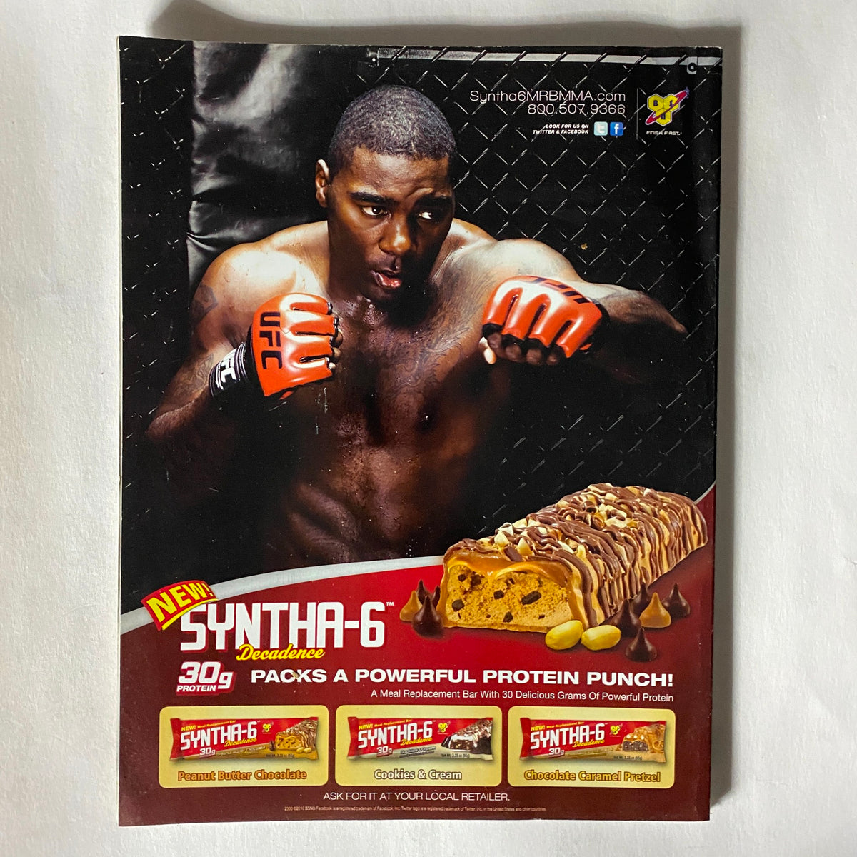 UFC Magazine December / January 2011 No. 8 featuring Georges St. Pierre, showcasing a powerful advertisement for Syntha-6 protein bars, highlighting its nutritional benefits with bold graphics and featuring an athlete in action.