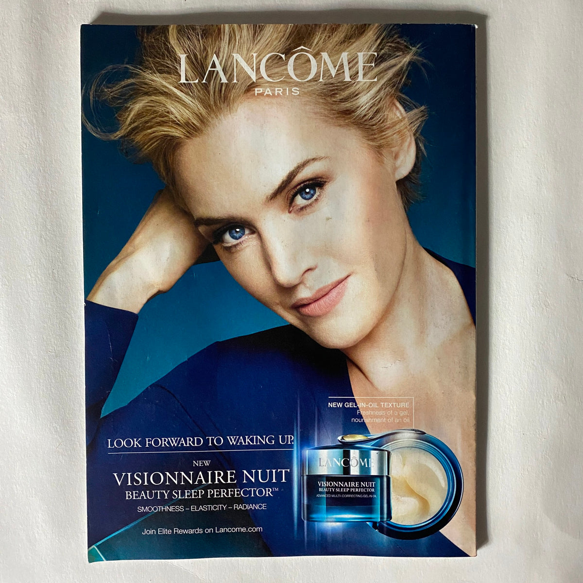 Advertisement from Vogue US Magazine January 2016 for Lancome with a beauty product showcased and a captivating image of a model.