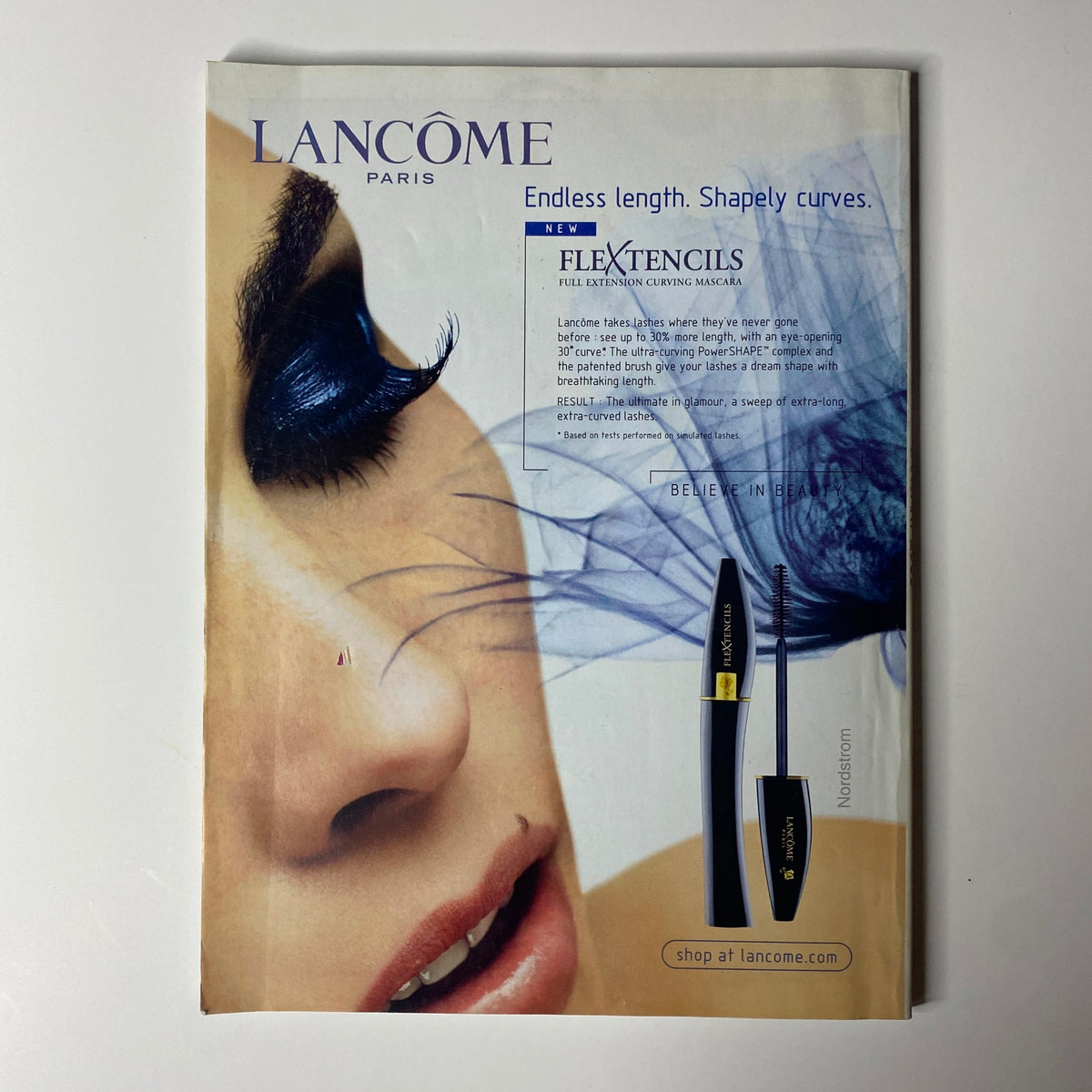 Vogue Magazine January 2003 includes an advertisement for Lancôme's new FlexTencils mascara, emphasizing beauty and elegance with a striking image of a model's eye.