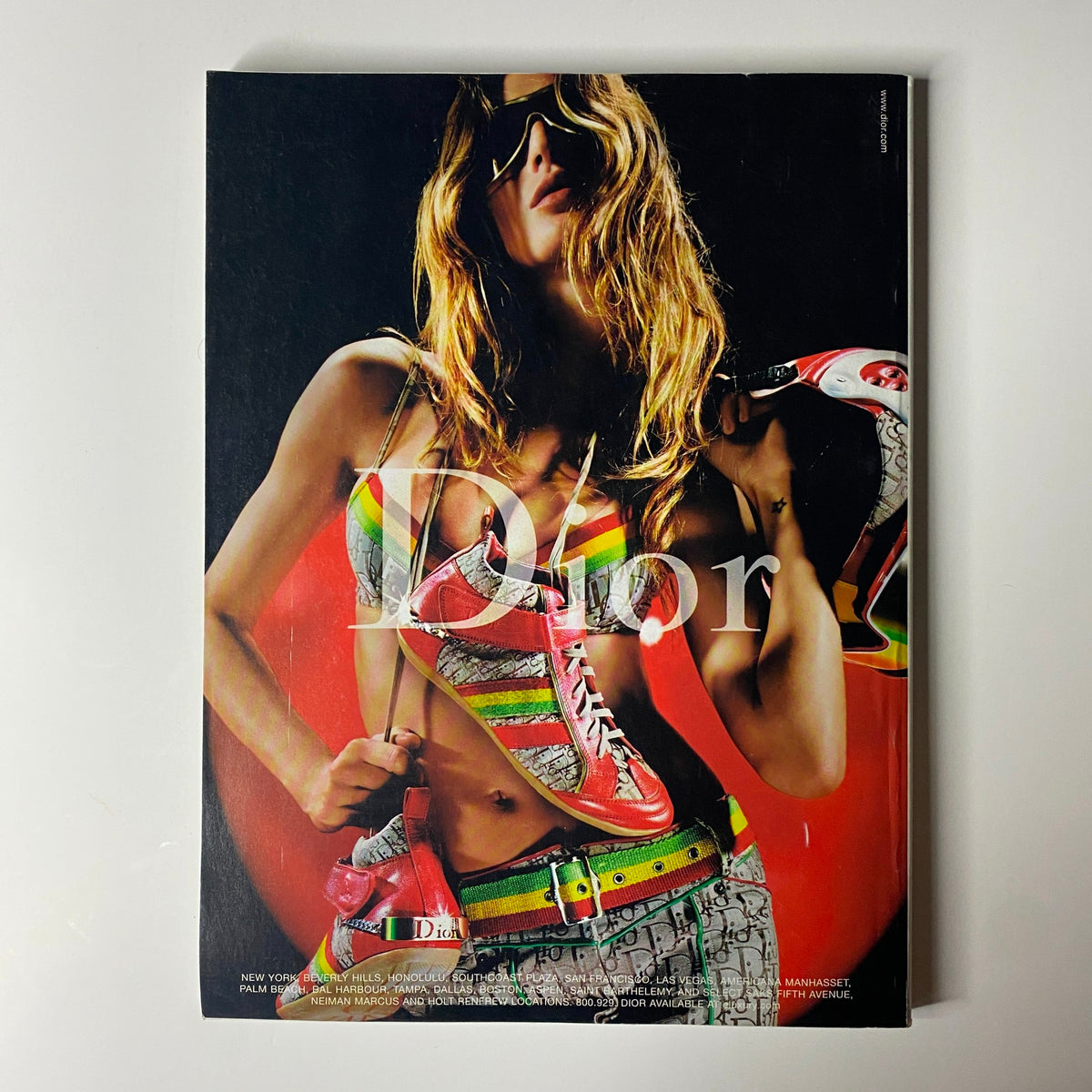 Cover page of Vogue Magazine August 2004 featuring Dior, showcasing a bold fashion statement with a model in vibrant attire, symbolizing the intersection of fashion and personal expression.