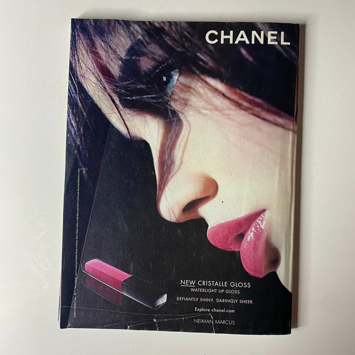 Chanel advertisement from Vogue Magazine June 2005 showcasing the new Cristalle Gloss lipstick. The image highlights a close-up of a woman's profile accentuated by bold, glossy lips and elegant makeup, embodying high fashion beauty.