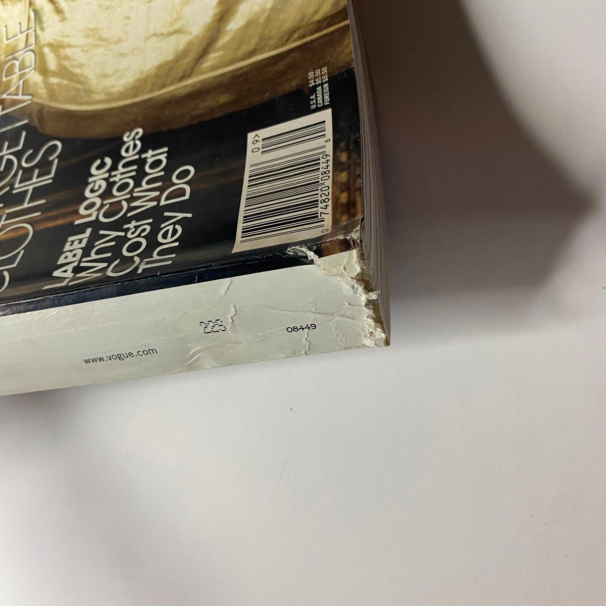 Close-up of the damaged spine of Vogue Magazine September 2005 displaying wear and tear, featuring Sarah Jessica Parker on the cover, emphasizing the magazine's vintage appeal.