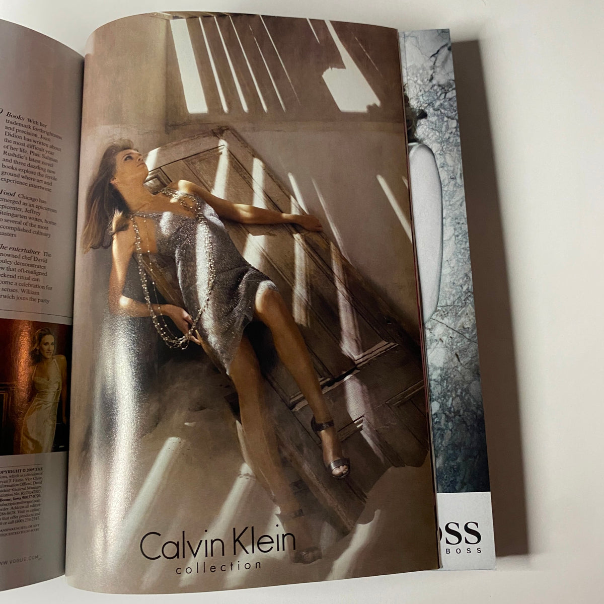 A high-fashion advertisement for Calvin Klein featured in Vogue Magazine September 2005, depicting a model in an elegant silver dress.