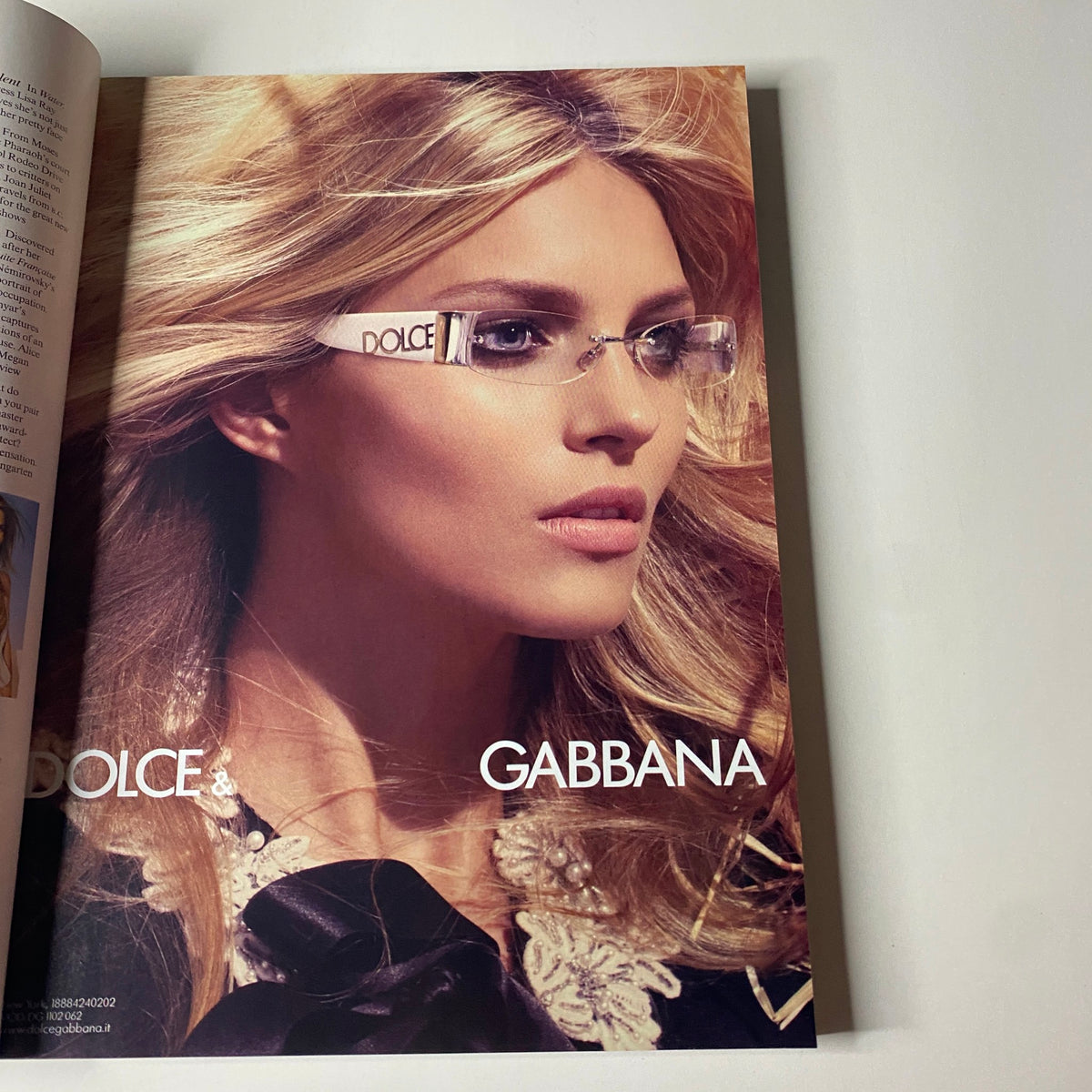 Dolce & Gabbana advertisement from Vogue Magazine April 2006 featuring a model with glamorous hair and stylish glasses, part of the Jennifer Aniston cover edition.