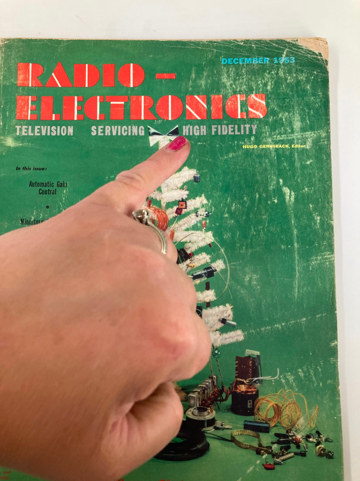 Close-up of the VTG Radio-Electronics Magazine December 1953 cover showcasing Automatic Gain Control, with a finger pointing at the title detail.