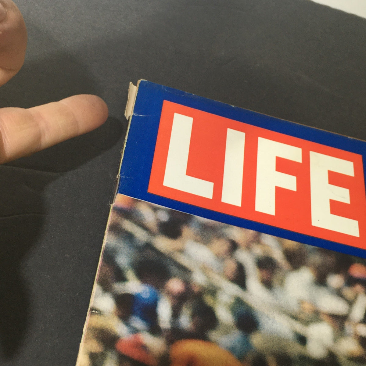 Top corner detail of Life Magazine September 26, 1969 cover, showcasing the title and a hand pointing to a minor defect