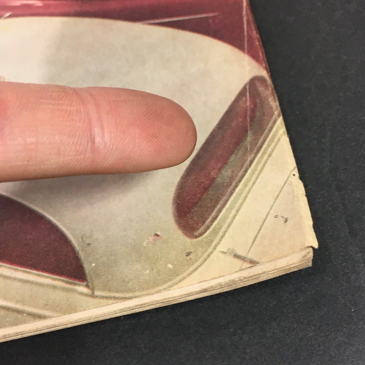 Close-up image showing the edge wear of Motor Trend Magazine - October 1953, emphasizing its vintage condition and collectible nature.