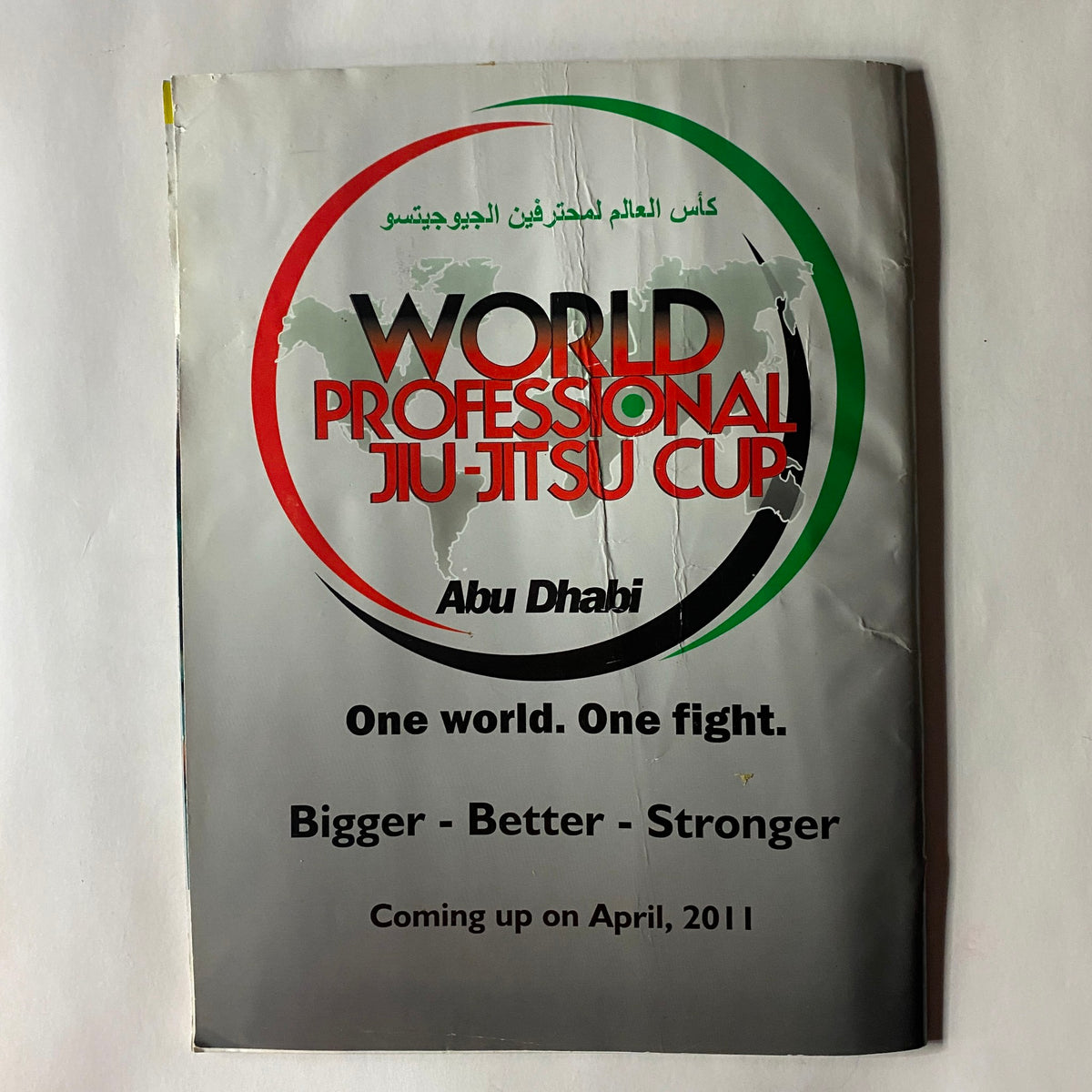 Cover of the World Professional Jiu-Jitsu Cup magazine, promoting the event scheduled in Abu Dhabi, featuring the tagline 'One world. One fight. Bigger - Better - Stronger.'