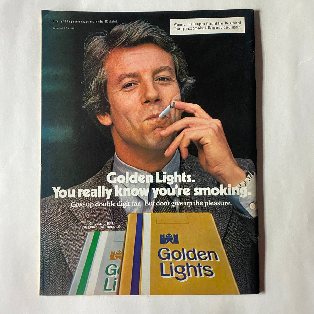 Vintage advertisement from the VTG Newsweek Magazine February 2, 1981 Ronald Reagan Special Issue featuring a man smoking a cigarette with promotional text for Golden Lights.