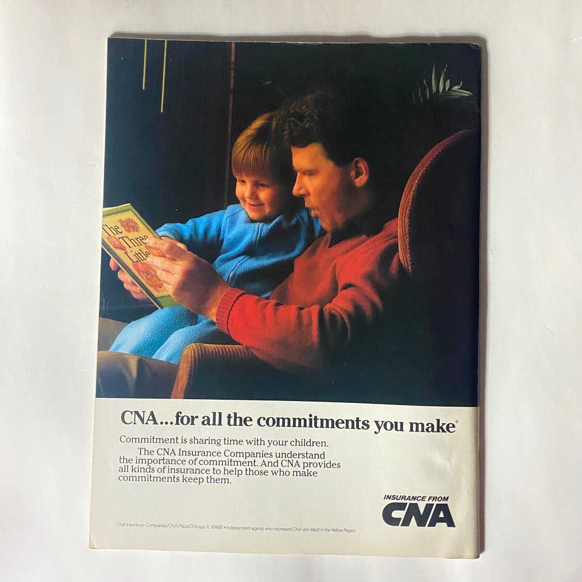 CNA Insurance advertisement featuring a father reading to his child, highlighting the importance of commitment to family.