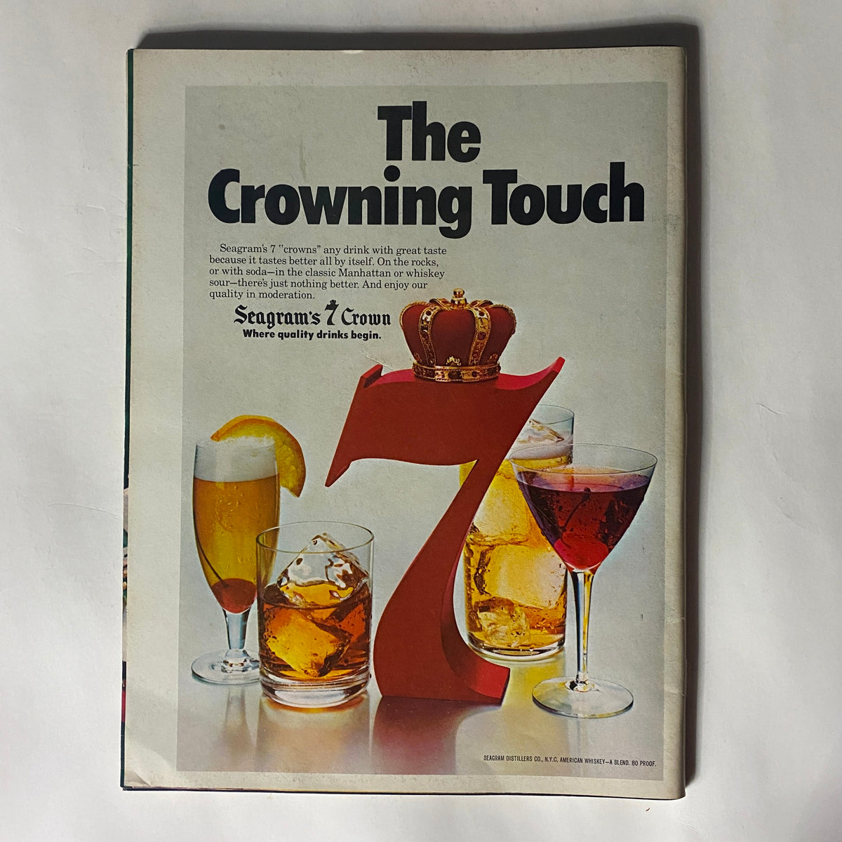 Inside page of the magazine featuring the Seagram's Crown advertisement titled 'The Crowning Touch', highlighting various drinks.
