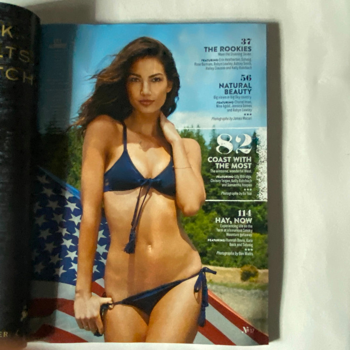 Article spread from Sports Illustrated Magazine Winter 2015 Swimsuit Issue featuring a model in a bikini beside an American flag.