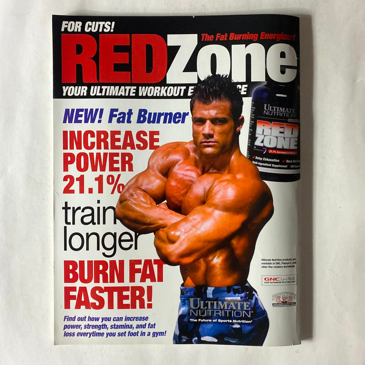 RED Zone magazine cover showcasing a muscular male model promoting fat-burning strategies and workouts, complementing the fitness theme of the November 2009 Fitness RX Magazine.