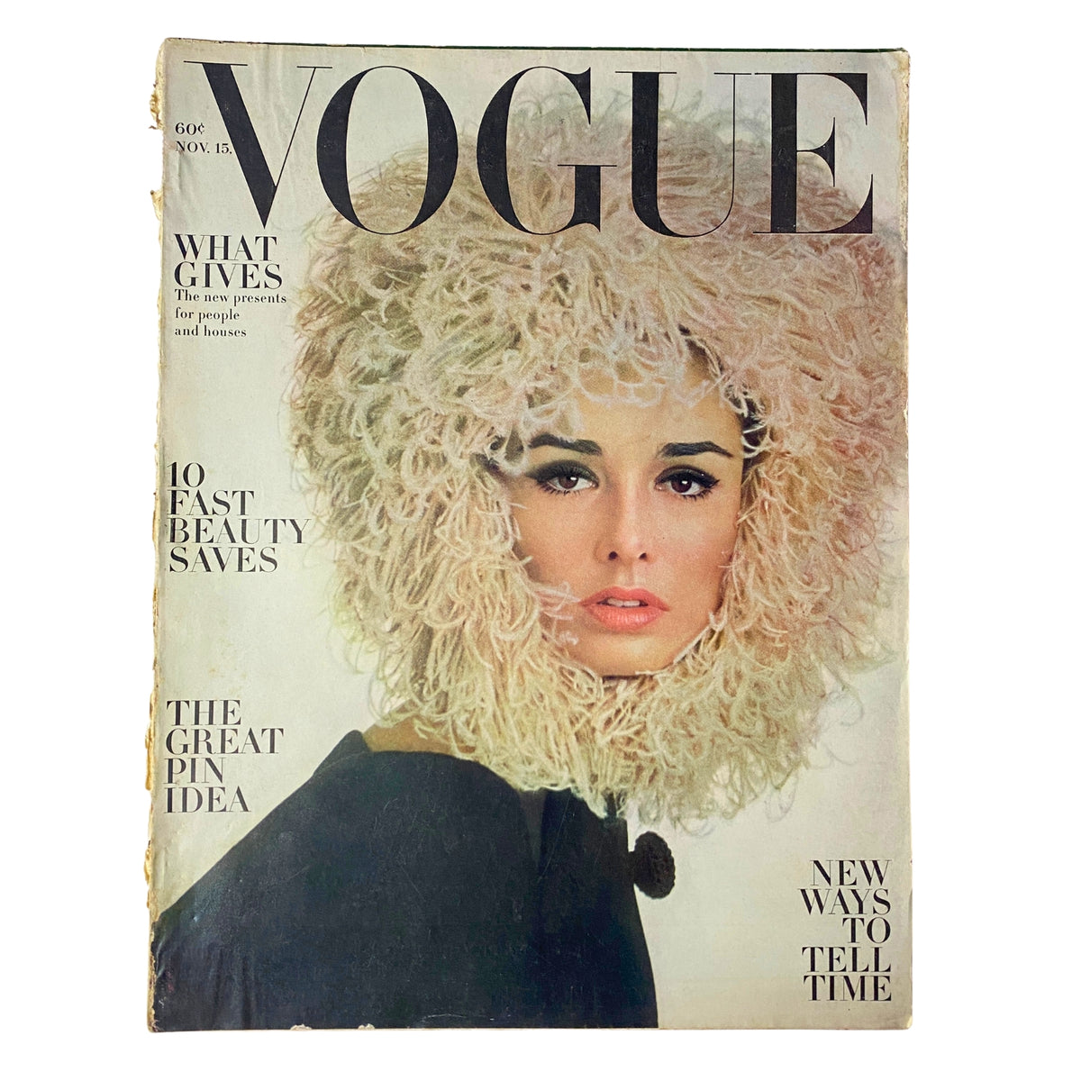 Vogue Magazine November 15, 1962 featuring a striking cover model Sondra Peterson with a dramatic hairstyle made of pink rope-thick feathers, highlighting fashion trends of the early 1960s.