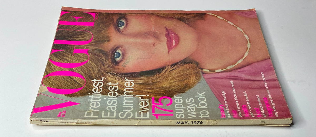 Side view of Vogue Magazine May 1976 with Rene Russo on the cover, showcasing the magazine's worn vintage condition and summer fashion theme.