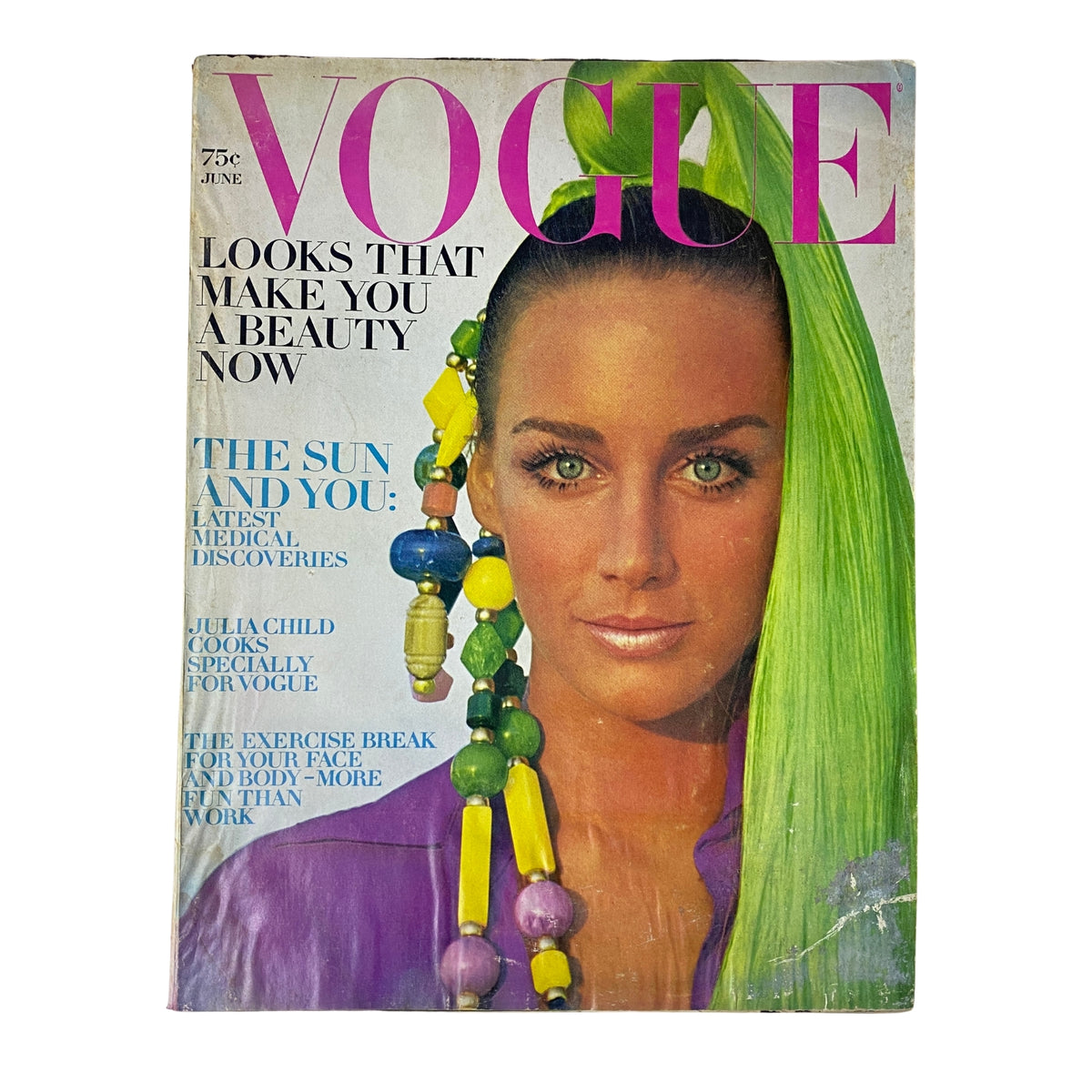 Vogue Magazine June 1969 featuring a cover image of a model with long green hair and colorful accessories, showcasing the theme 'Looks That Make You a Beauty Now'.
