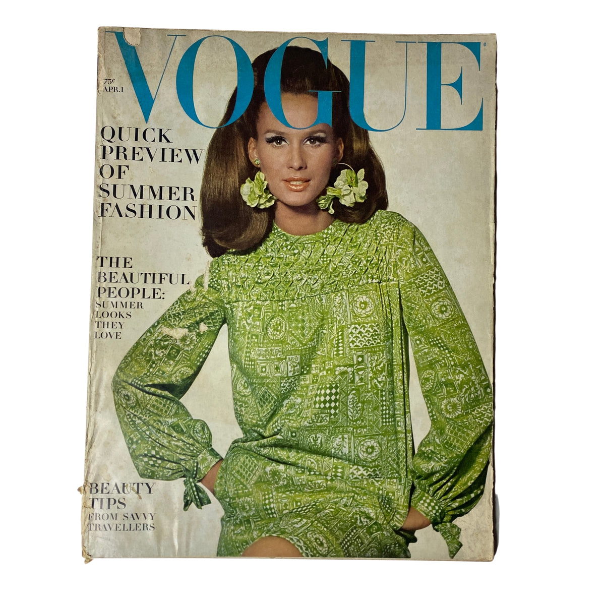 Vogue Magazine April 1, 1966 featuring Brigitte Bauer on the cover, showcasing a vibrant green patterned dress with large flower earrings.