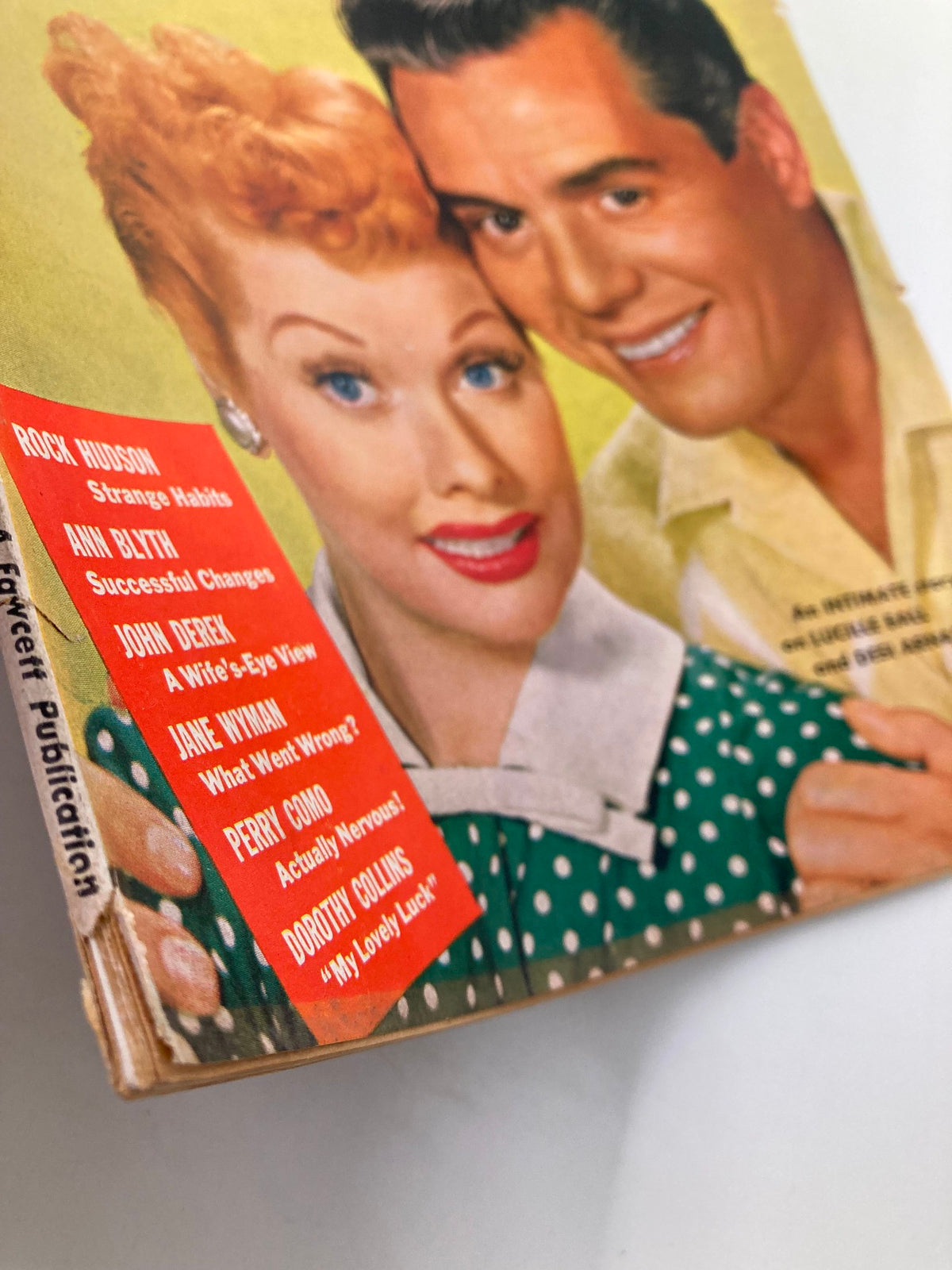 Close-up of the cover of VTG Motion Picture and Television Magazine May 1954, with Lucille Ball and Desi Arnaz, emphasizing vintage advertisements and colorful design.