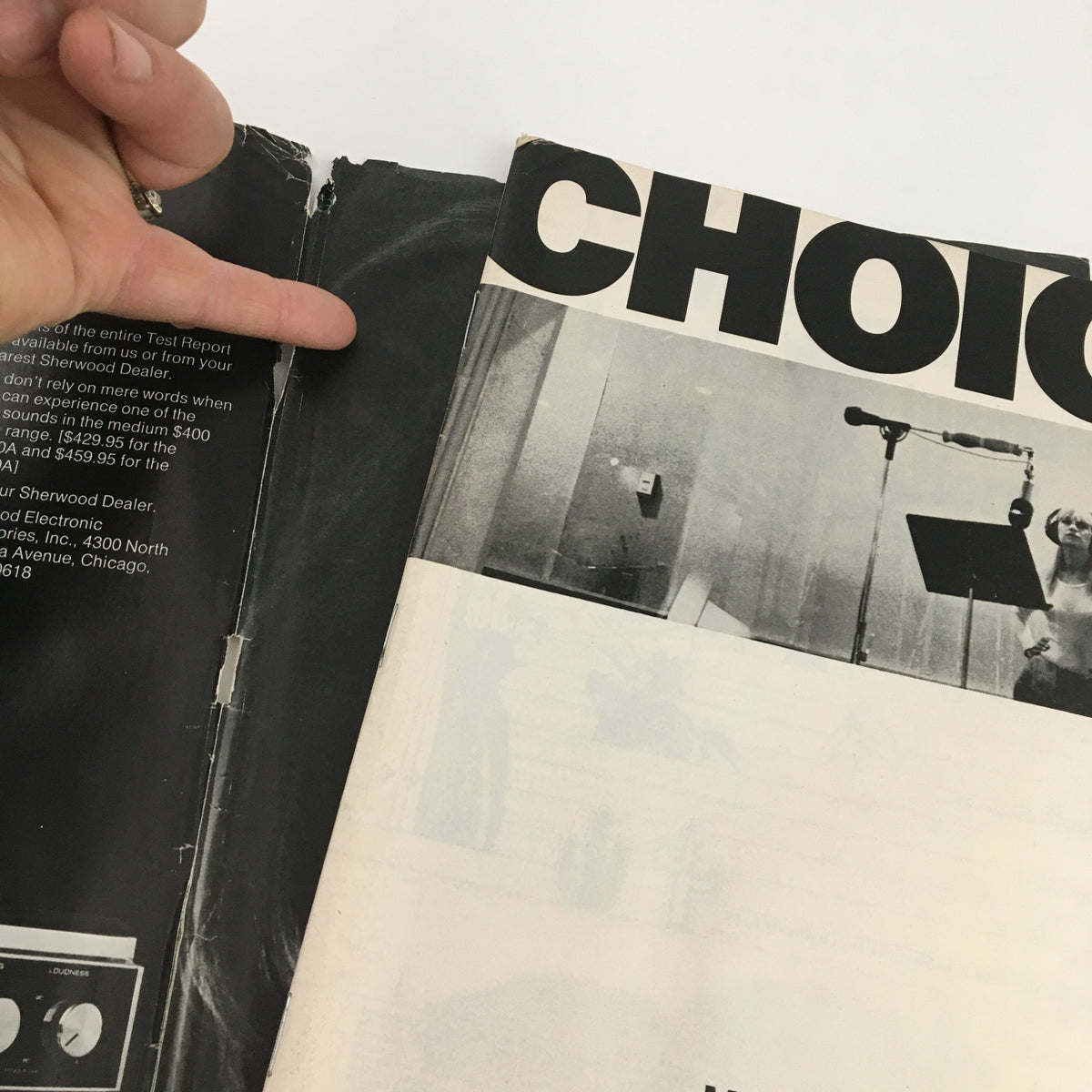 Side view of National Lampoon Humor Magazine, March 1973, showing wear and a detached section, illustrating its vintage condition.