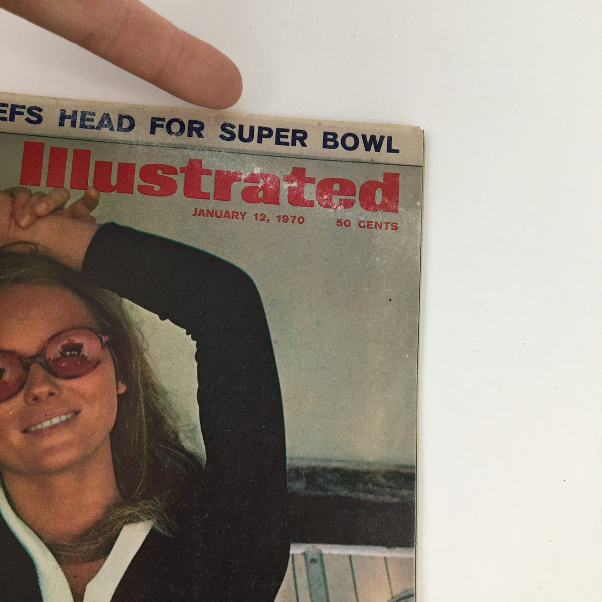 Close-up of the cover of Sports Illustrated Magazine, January 12, 1970, showcasing the title 'Bobby Mines - The Mother Lode', with a woman wearing stylish sunglasses, highlighting the magazine's thematic connection to sports and fashion.