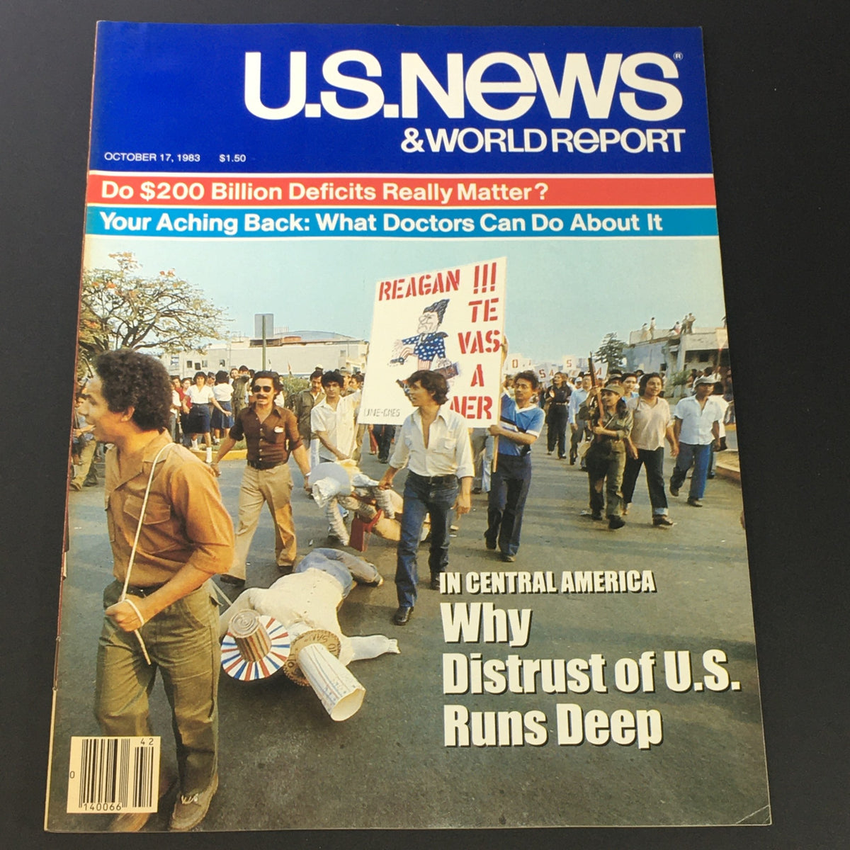 U.S. News & World Report Magazine Cover from October 17, 1983, featuring a protest scene with demonstrators and a sign referencing Reagan, highlighting the article on distrust of the U.S.
