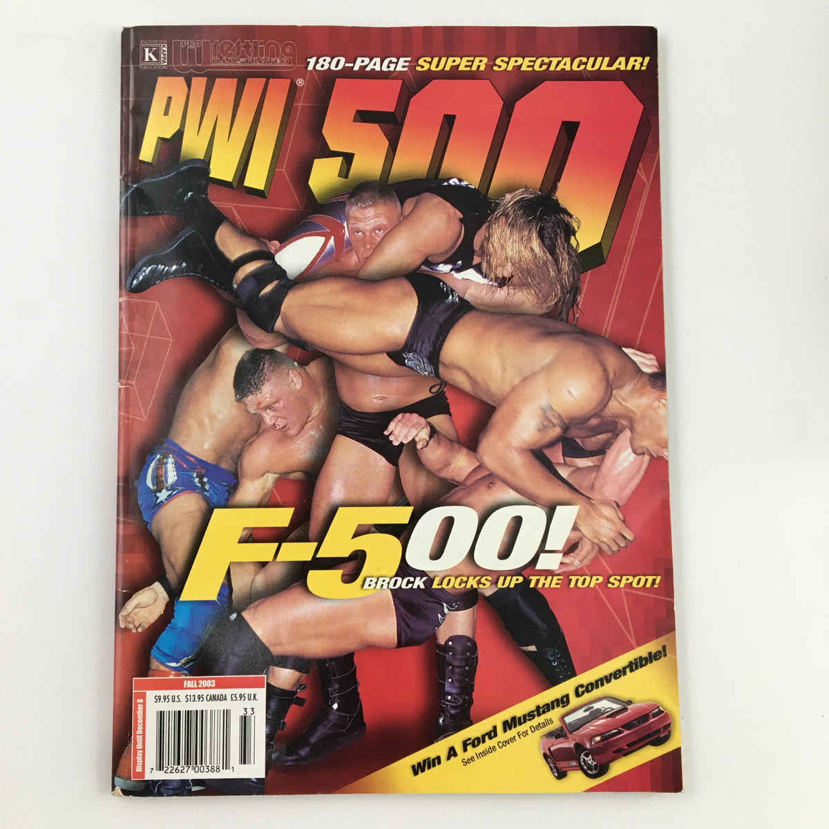 Pro Wrestling Illustrated Magazine Fall 2003 featuring Brock Lesnar and Kurt Angle on the cover, showcasing intense wrestling action with multiple wrestlers in a competitive scene.