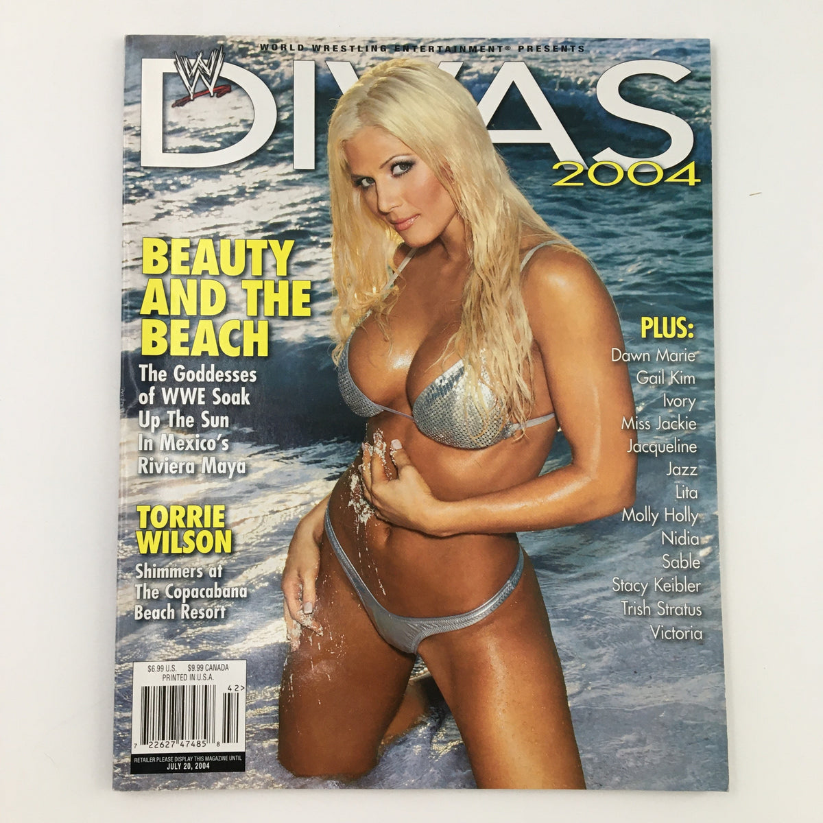 WWE Divas Magazine 2004 featuring Torrie Wilson on the cover, showcasing her in a silver bikini by the beach.