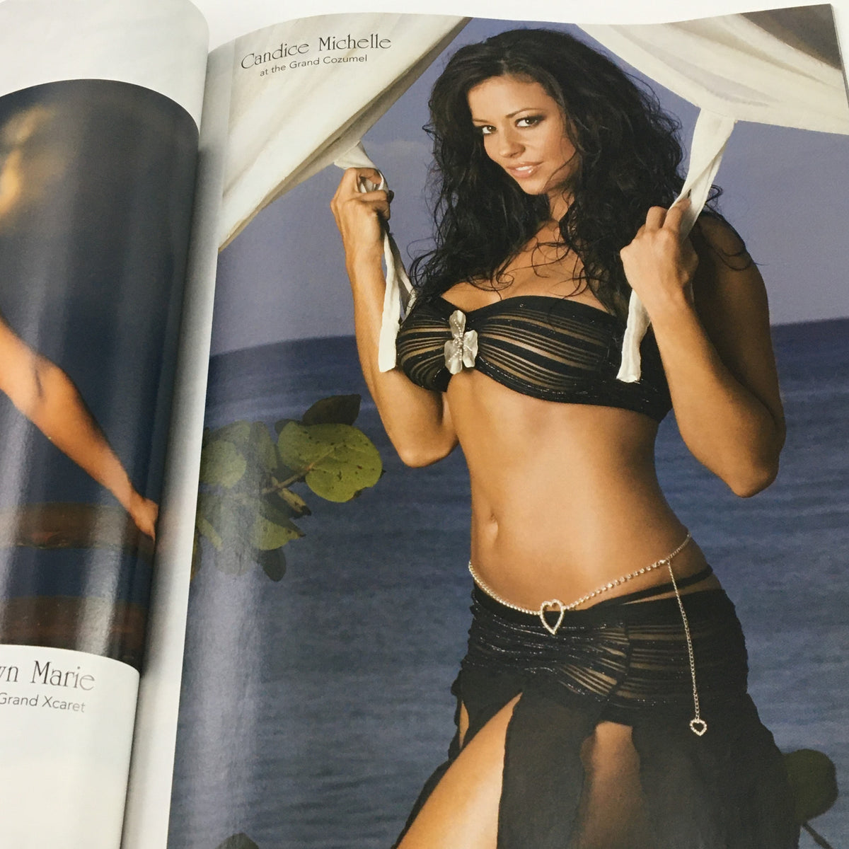 WWE Divas Magazine 2005 showing Candice Michelle in a seductive black outfit by the ocean, capturing the glamorous lifestyle of wrestling divas.