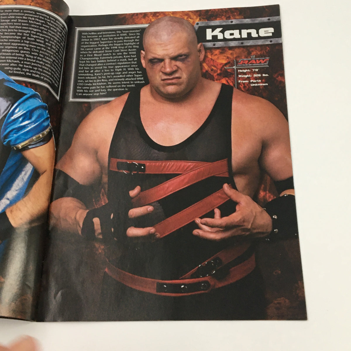 Interior page of WWE Raw Magazine 2003 featuring Kane, showcasing the professional wrestler's fierce persona and character within WWE. This page highlights Kane's role and his legacy in wrestling history.