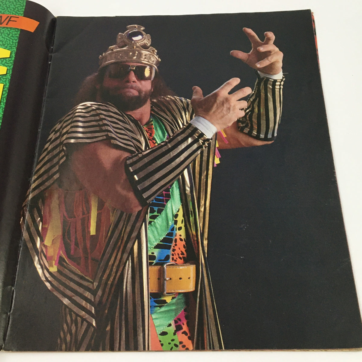 Full-page photo of Randy Savage dressed in colorful wrestling attire, wearing a crown and sunglasses, featured in the June 1990 WWF Magazine.