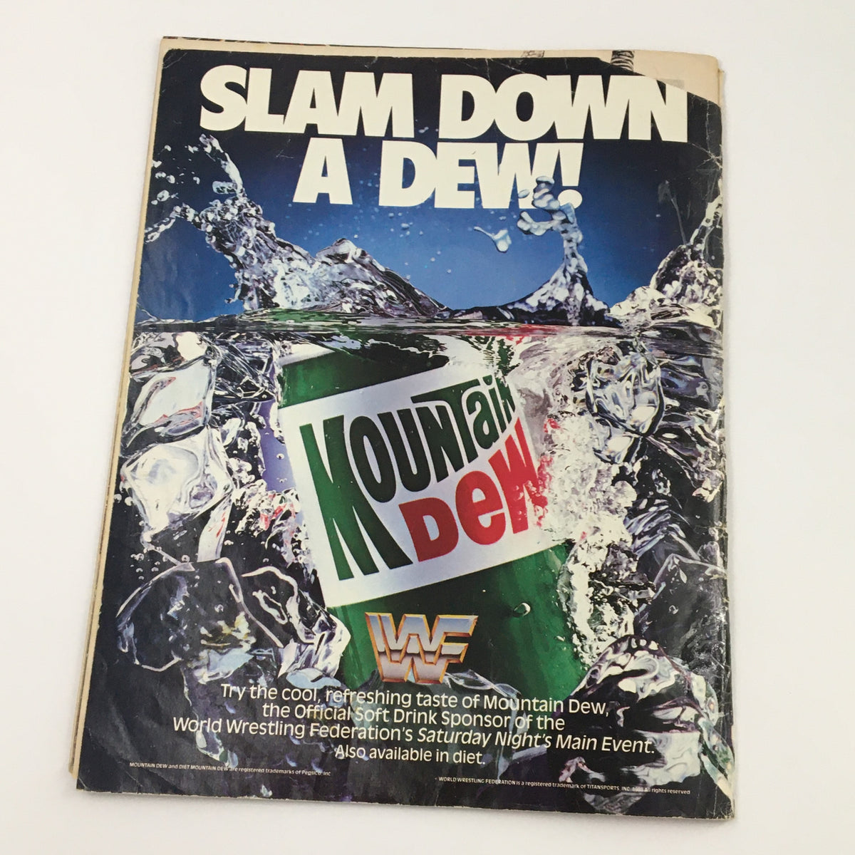 WWF Magazine June 1990 showcasing a vibrant advertisement featuring Mountain Dew with the slogan 'SLAM DOWN A DEW!', capturing the excitement of wrestling's golden era.