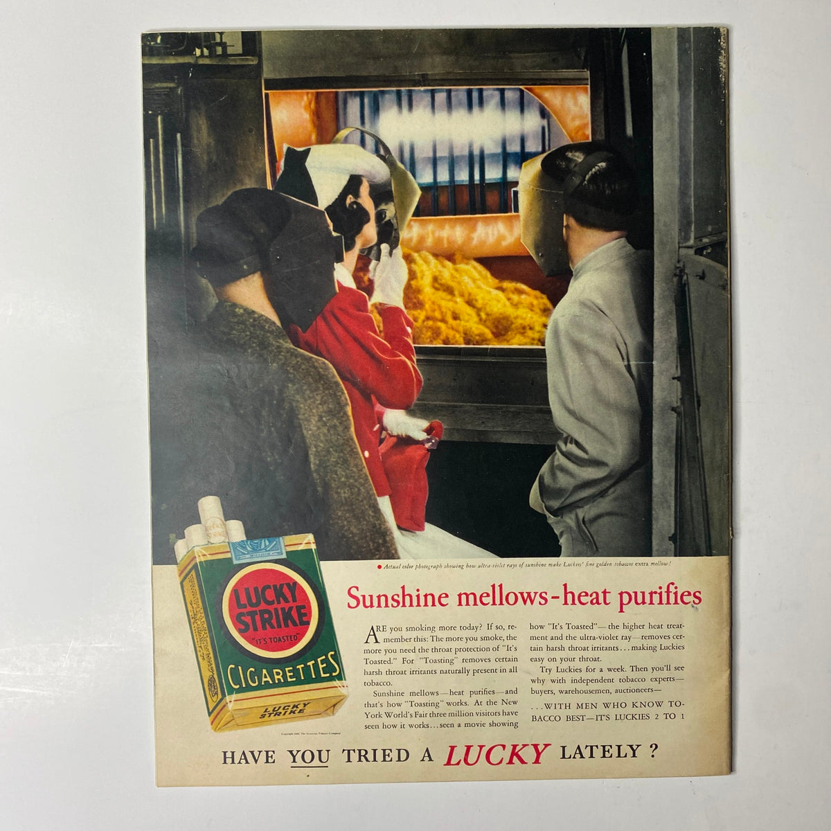 Vintage advertisement for Lucky Strike cigarettes from Look Magazine, June 4, 1940, promoting how 'Sunshine mellows-heat purifies'. The ad creatively depicts people with gas masks.