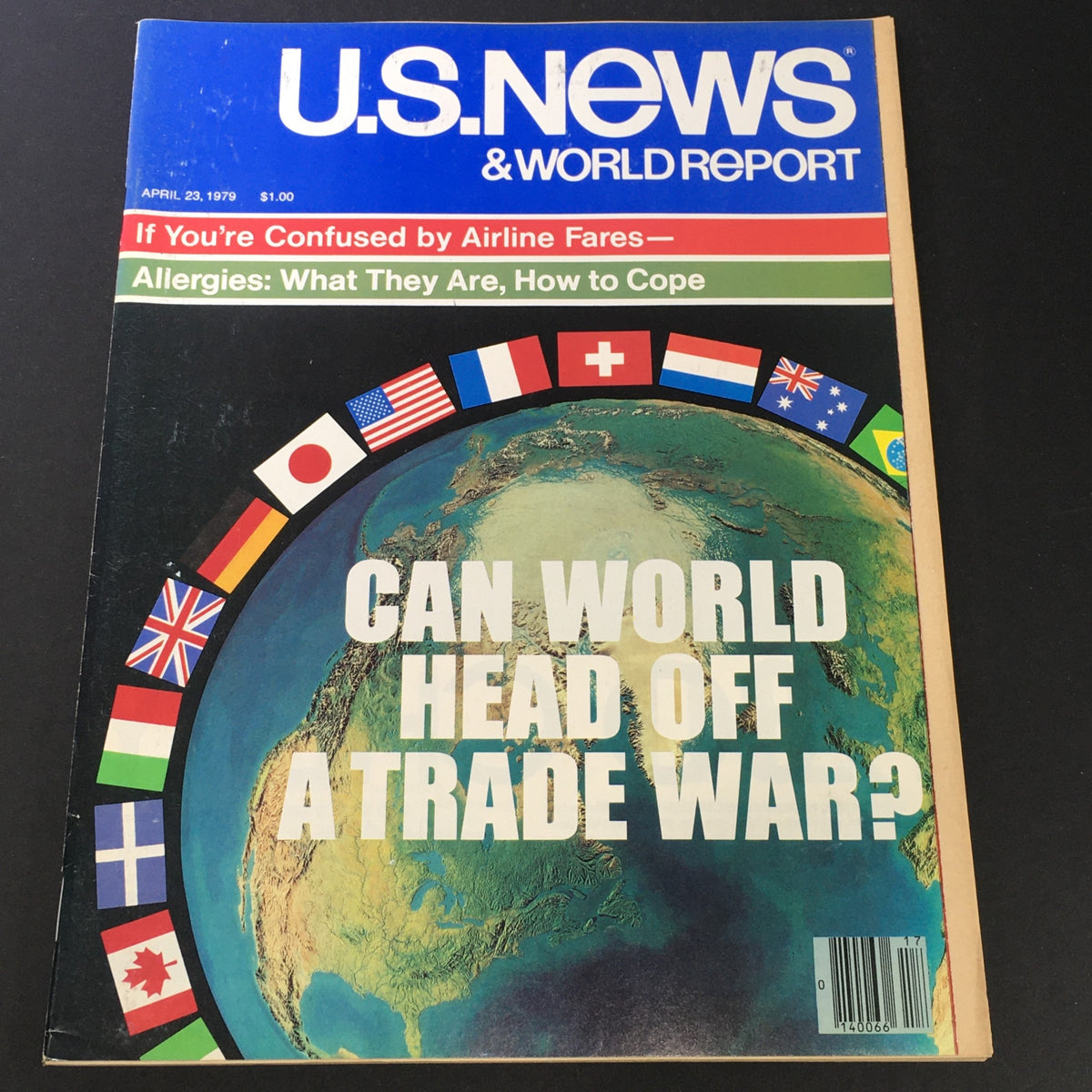 Cover of U.S. News & World Report magazine from April 23, 1979, featuring the headline 'Can World Head Off A Trade War?' and images of flags from various countries, reflecting the era's economic discussions.