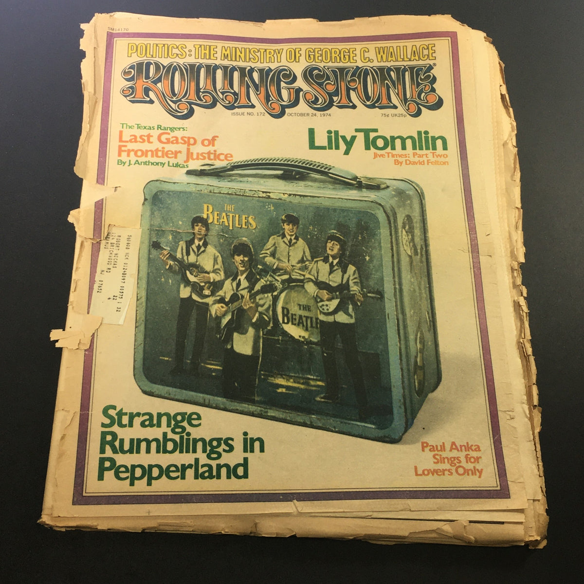 Vintage Rolling Stone Magazine from October 24, 1974, featuring The Beatles and Lily Tomlin on the cover, showcasing a significant moment in music history.