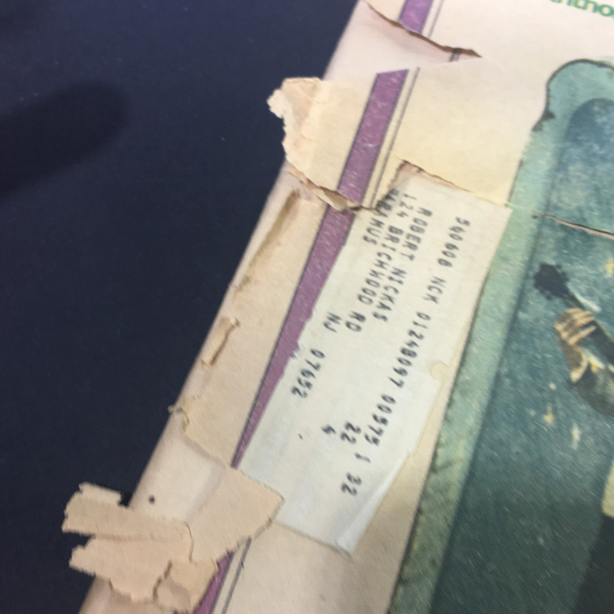 Close-up of the corner of a vintage Rolling Stone Magazine from October 24, 1974, highlighting wear and an old address label, emphasizing its collectible nature.