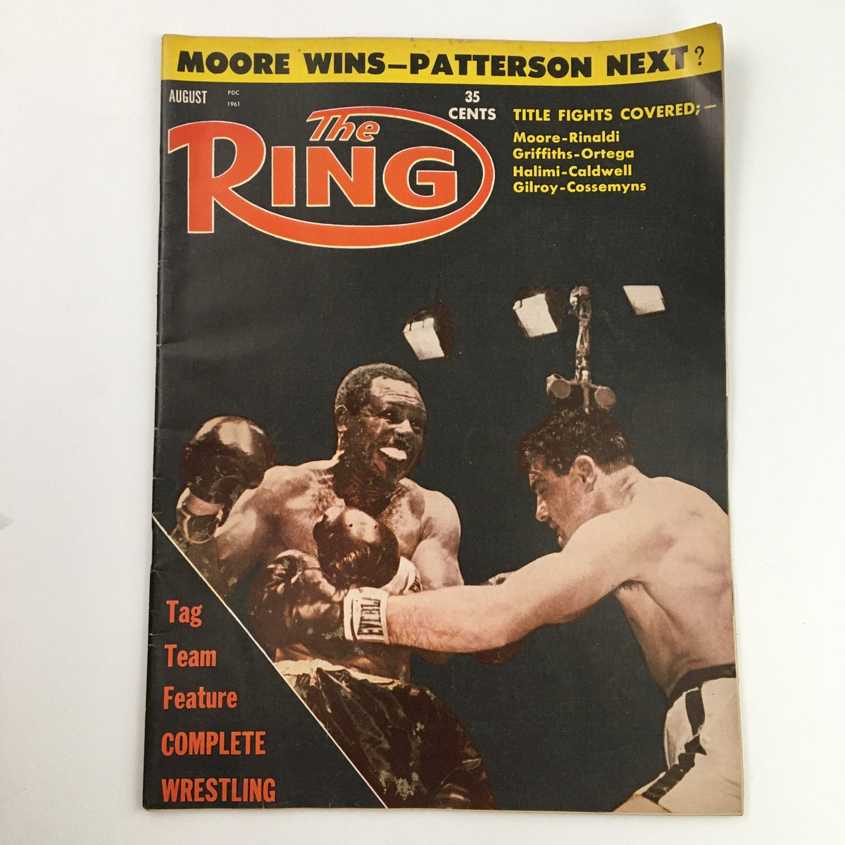 The Ring Boxing Magazine August 1961 featuring Archie Moore vs Giulio Rinaldi on the cover, showcasing a boxing match scene with bold headlines.
