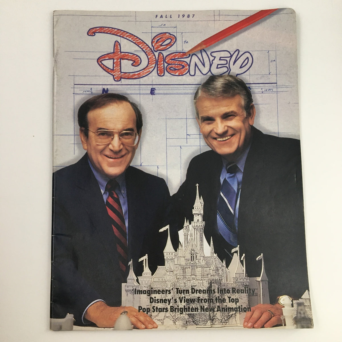 Cover of the Disney News Magazine Fall 1987 featuring two men smiling, celebrating Disney's Idea Factory's 35th anniversary of creativity.