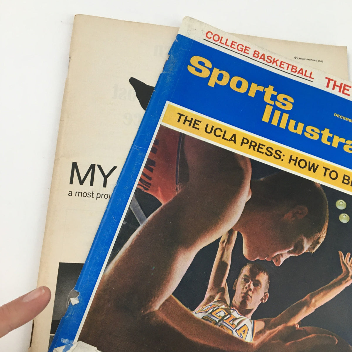 Detailed view of the cover of Sports Illustrated Magazine, December 6, 1965, highlighting the title 'The UCLA Press: How To Beat It' with an image of basketball players.