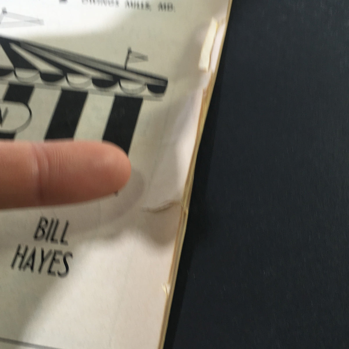 Detail of the vintage program page showing a small tear, highlighting the wear that reflects its authenticity from the Painters Mill Music Fair event of July 14, 1966.