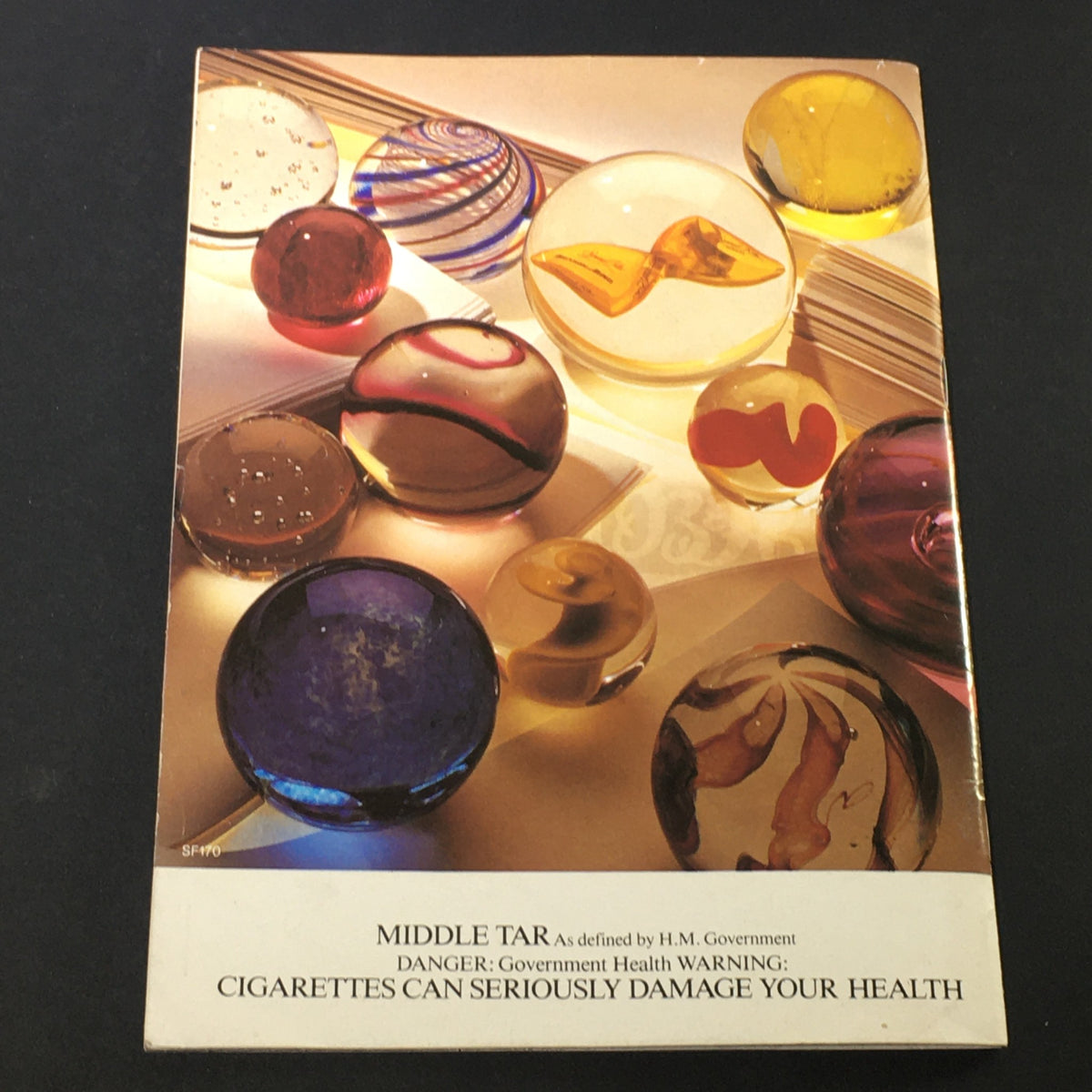 Cover of the vintage magazine featuring colorful glass marbles, part of the VTG Queens Stoll Moss Theatre November 1985 issue, showcasing Maggie Smith in Interpreters.