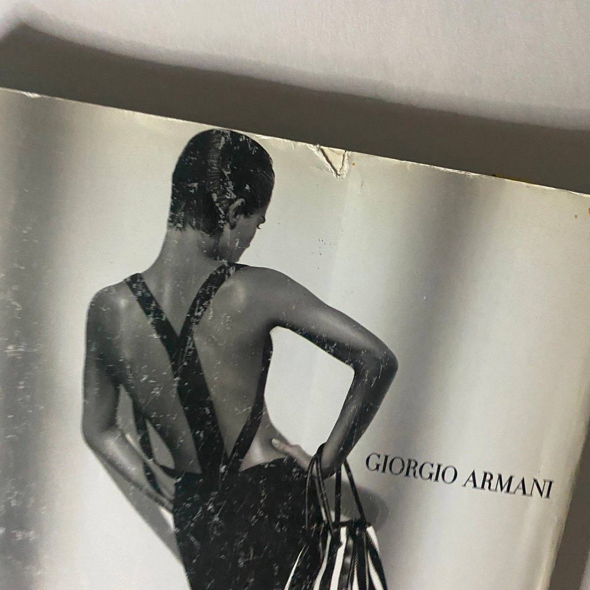 Close-up of the cover of Numéro Magazine February 2004 No. 50 displaying a model in a Giorgio Armani design, emphasizing classic fashion with a modern twist.