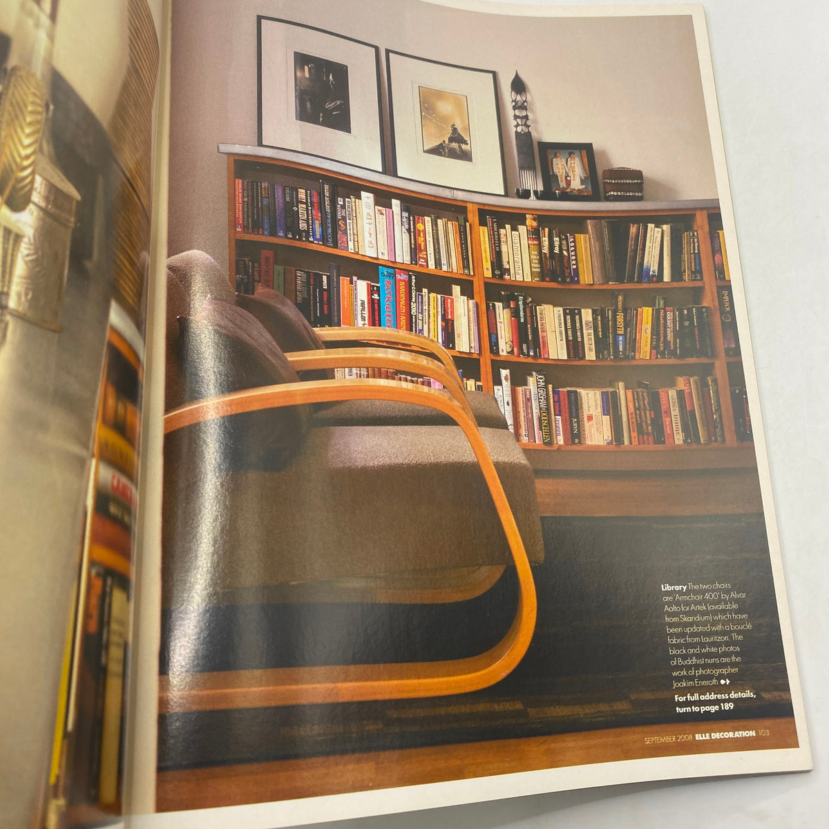 Interior photo from Elle Decoration UK Edition Magazine September 2008 showing a cozy reading nook with a modern chair and a rich collection of books on a bookshelf, emphasizing style and comfort.