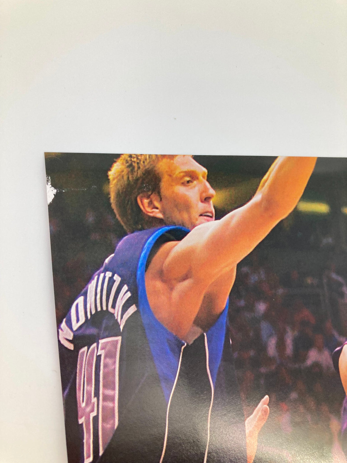 Action shot of basketball player with the last name 'Nowitzki', showcasing athleticism on the court, featured in Slam Magazine August 2005 Indiana Pacers Ron Artest w Poster No Label.