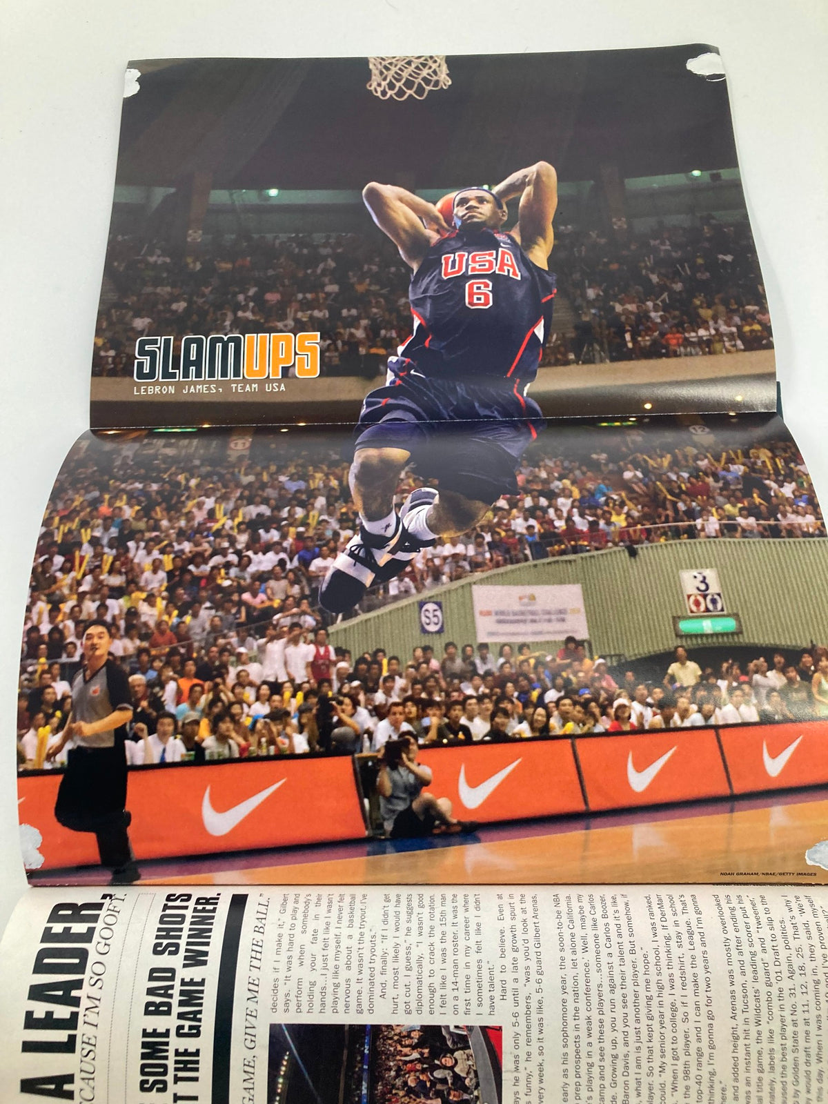 Slam Magazine November 2006 poster featuring LeBron James with Team USA, showcasing him in action during a basketball game. Vintage collectible from Slam Magazine.