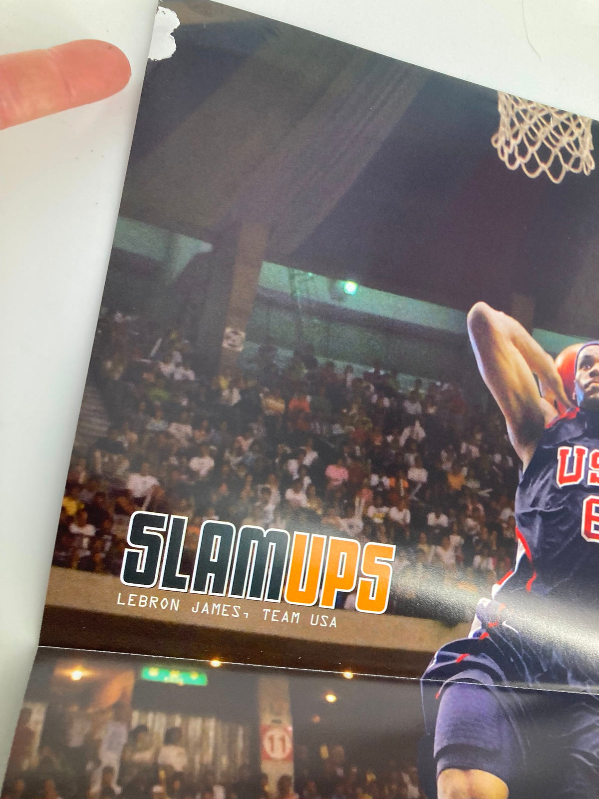 Close-up of the Slam Magazine November 2006 poster of LeBron James with Team USA, highlighting the dynamic leap and intense action captured on the poster.