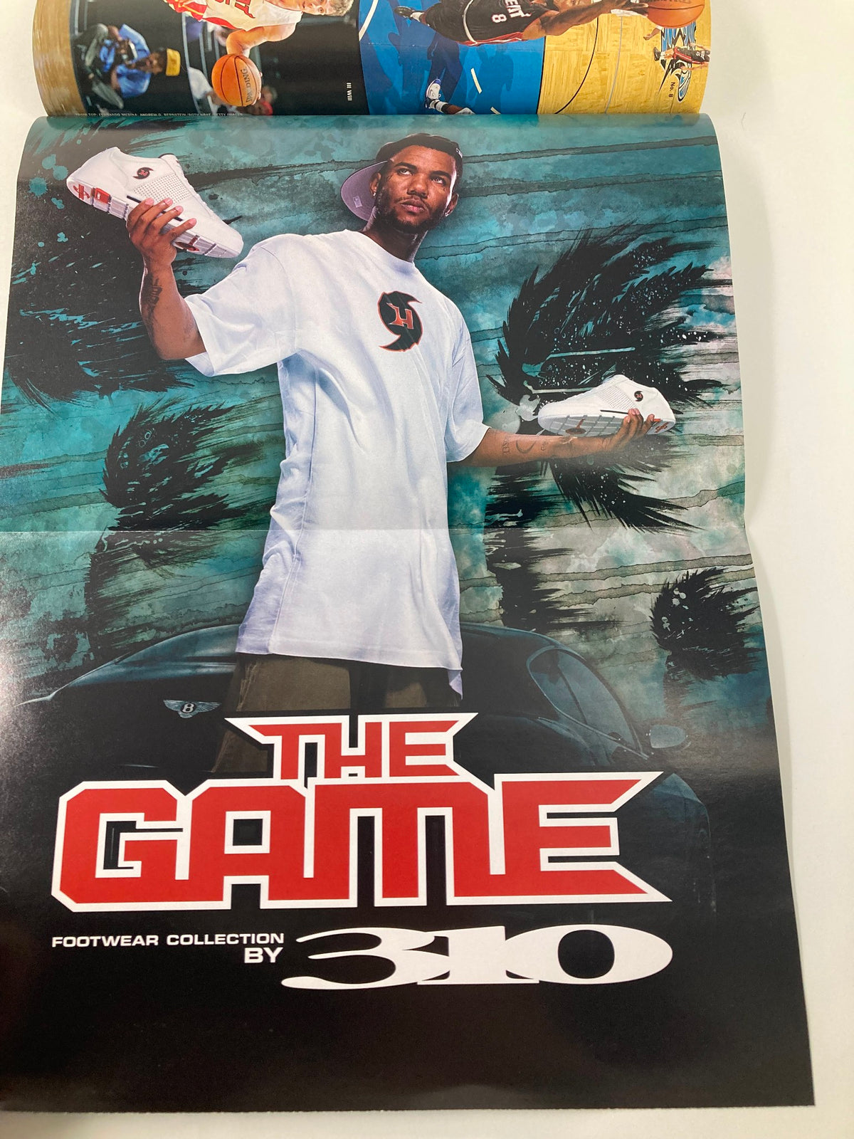 Slam Magazine February 2006 featuring Dwyane Wade and Shaquille O'Neal, highlighting iconic basketball culture with a promotional poster of 'The Game' footwear collection by 310.